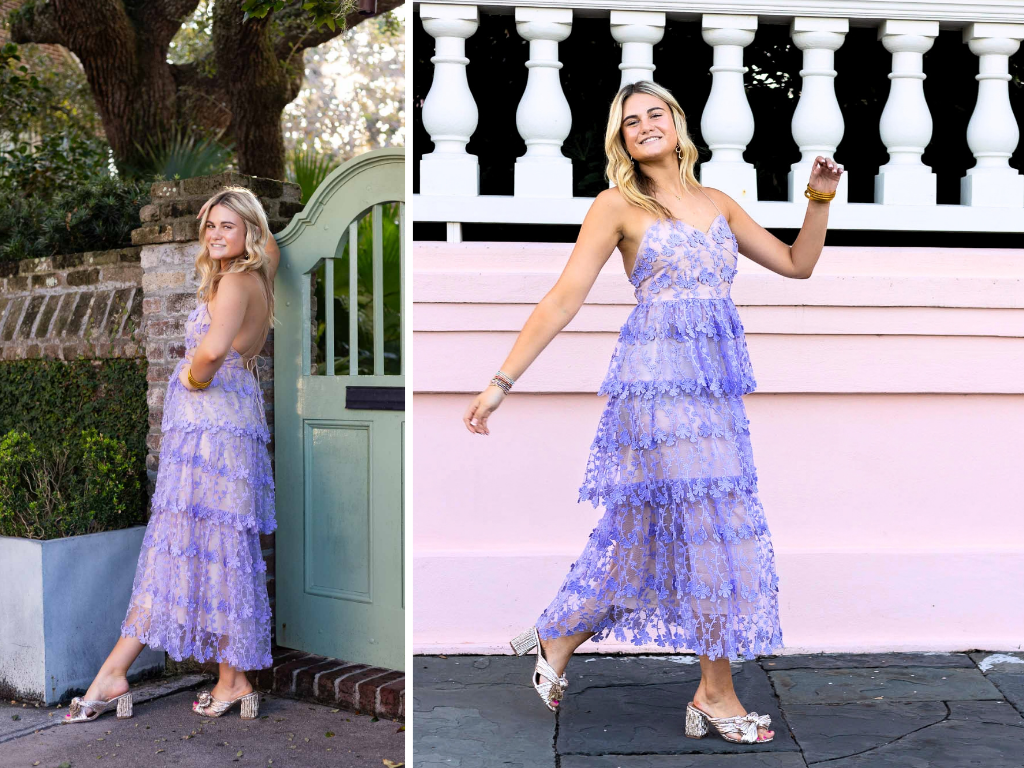 A senior girl poses in a lavender lace dress by a garden gate and in front of a pink wall during her senior session.