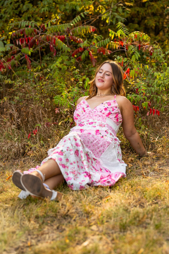 Lawrence KS senior photos at Clinton Lake Park, senior in pink floral dress with bouquet and heels