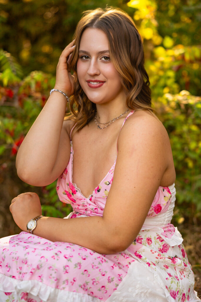 Lawrence KS senior photos at Clinton Lake Park, senior in pink floral dress with bouquet and heels