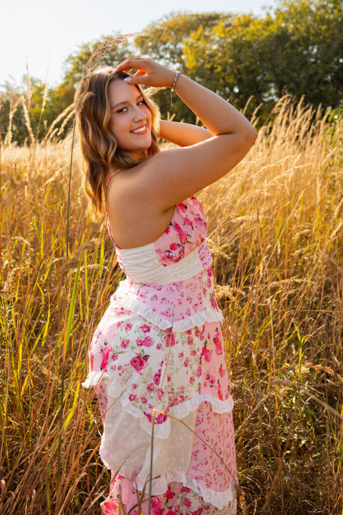 Lawrence KS senior photos at Clinton Lake Park, senior in pink floral dress and heels