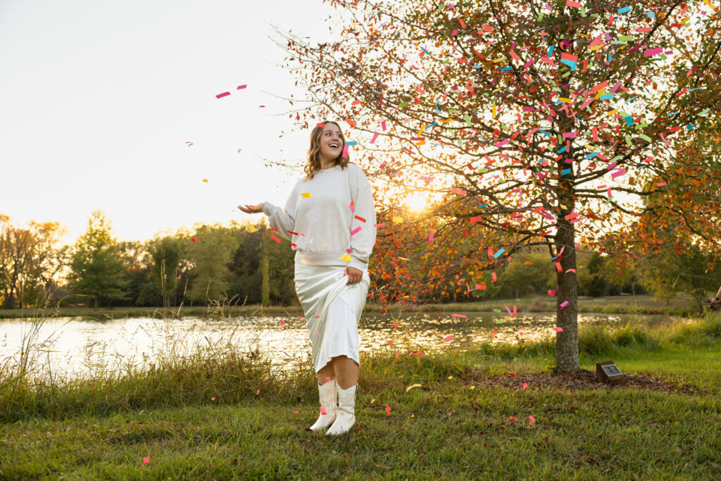 Lawrence KS senior portraits at the Lawrence Arboretum, senior in white dress, sweater, and white boots