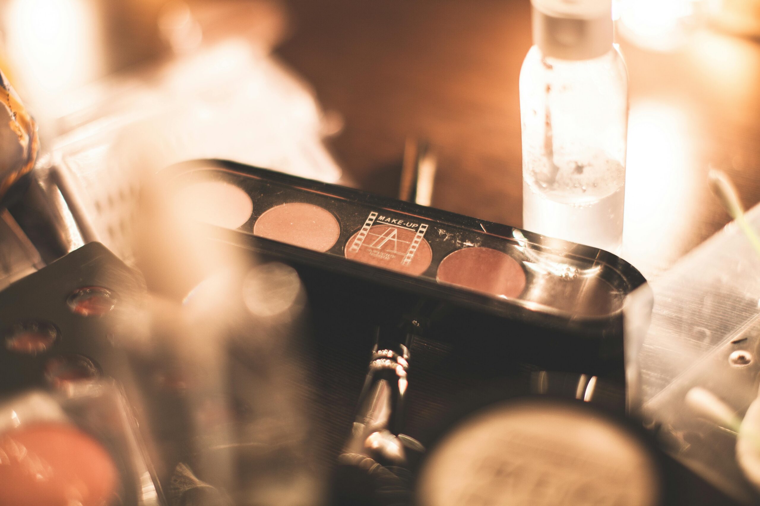 Senior girl getting professional hair and makeup done before her senior session at Megan Bowers Photography in Lawrence KS