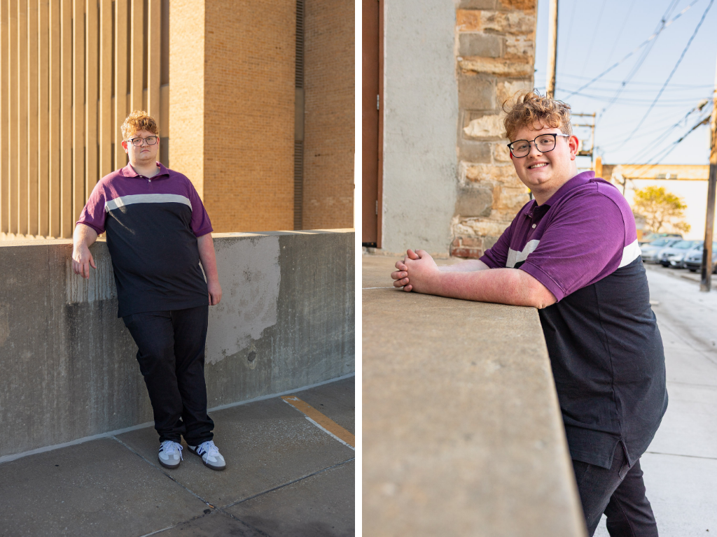 Senior in a purple color-block polo leaning against textured walls in a Downtown Lawrence alley