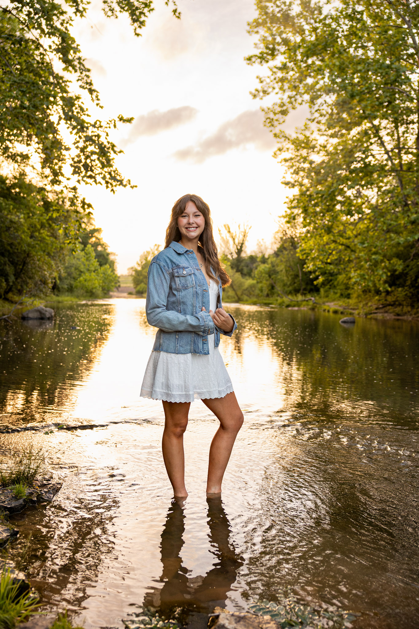 Golden hour creek senior portrait in Lawrence KS, an example of what the cost of senior pictures includes