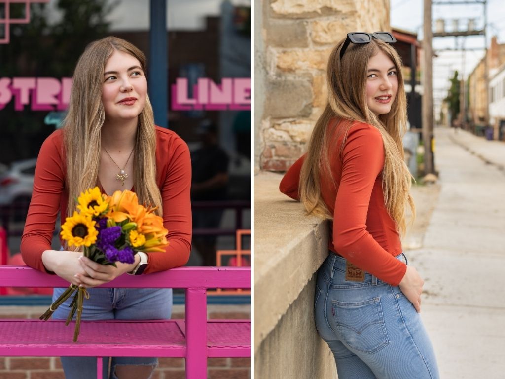 Lily leaning on a pink bench holding sunflowers, and looking over her shoulder against a stone wall downtown